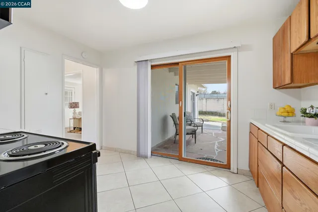 a kitchen with granite countertop a stove top oven and cabinets