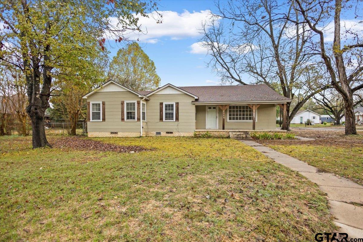 2707 Dudley Road Kilgore, TX 75662 - Photo 1 of 29 a front view of a house with a garden and trees