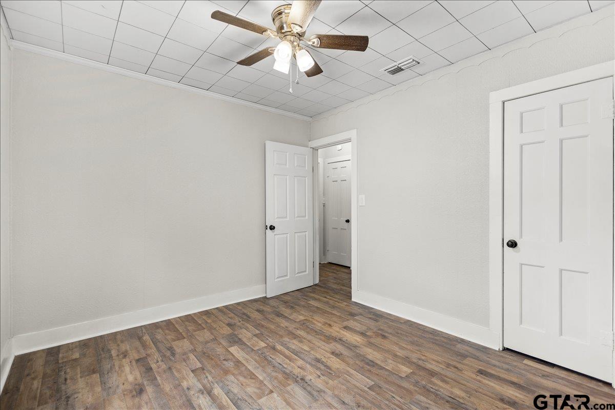 2707 Dudley Road Kilgore, TX 75662 - Photo 17 of 29 wooden floor in an empty room with a window