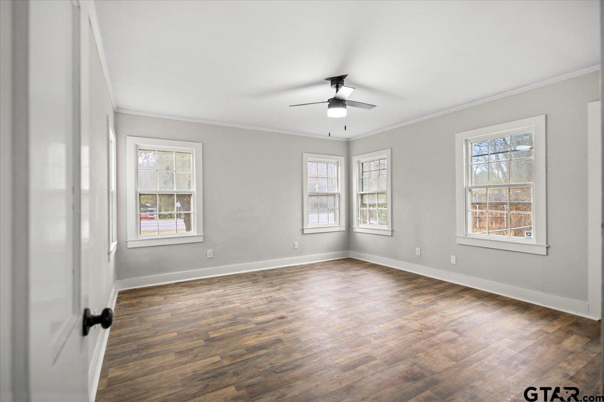 2707 Dudley Road Kilgore, TX 75662 - Photo 21 of 29 a view of an empty room with a window and wooden floor