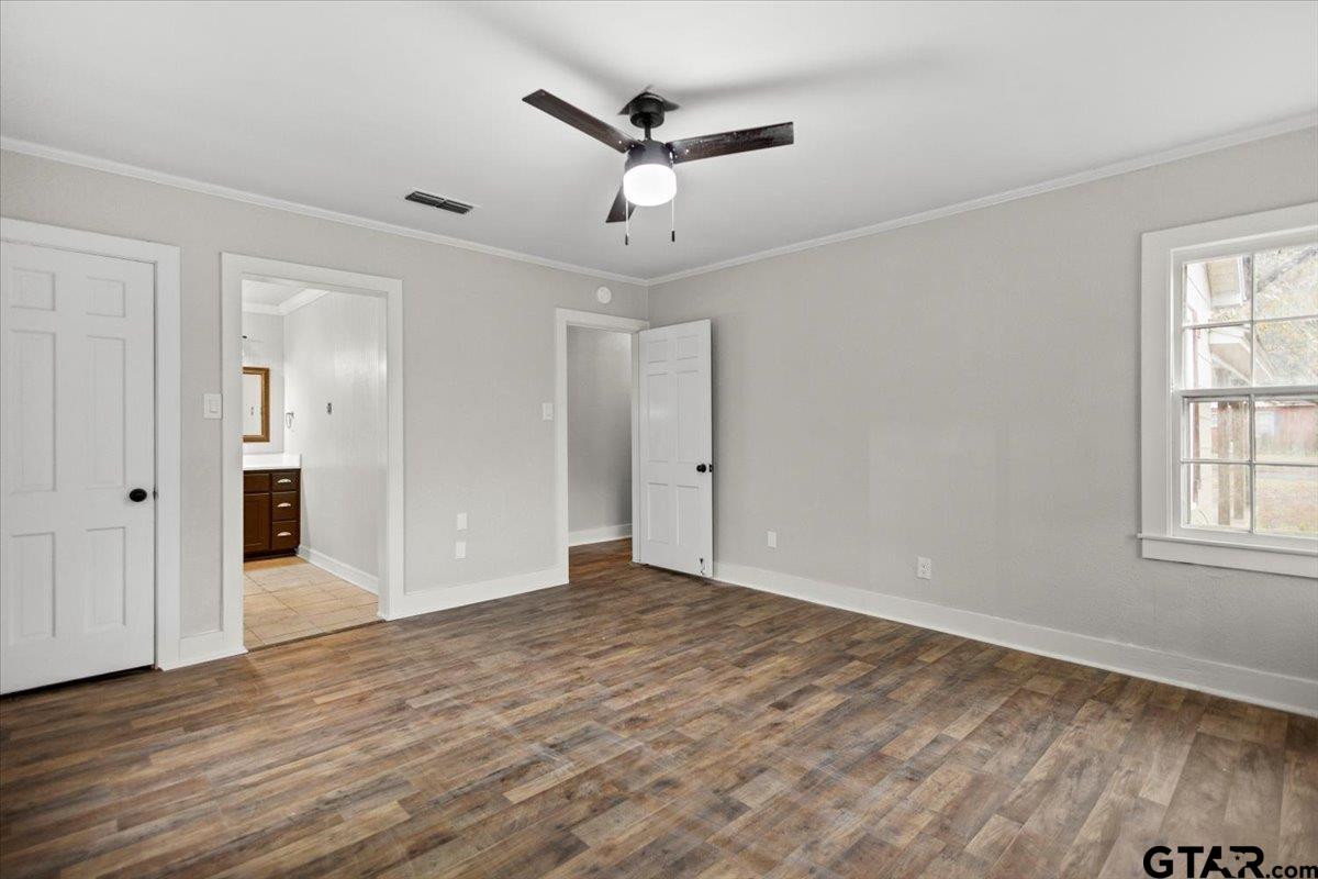 2707 Dudley Road Kilgore, TX 75662 - Photo 23 of 29 wooden floor in an empty room with a window
