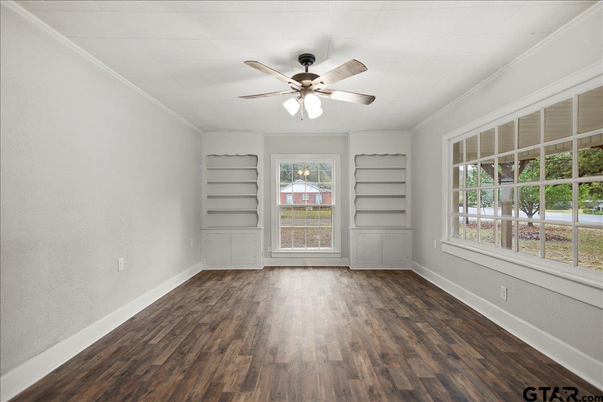 2707 Dudley Road Kilgore, TX 75662 - Photo 4 of 29 a view of a livingroom with wooden floor and a ceiling fan