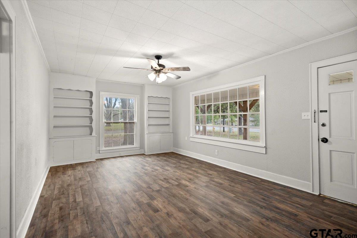 2707 Dudley Road Kilgore, TX 75662 - Photo 5 of 29 a view of an empty room with a window and wooden floor