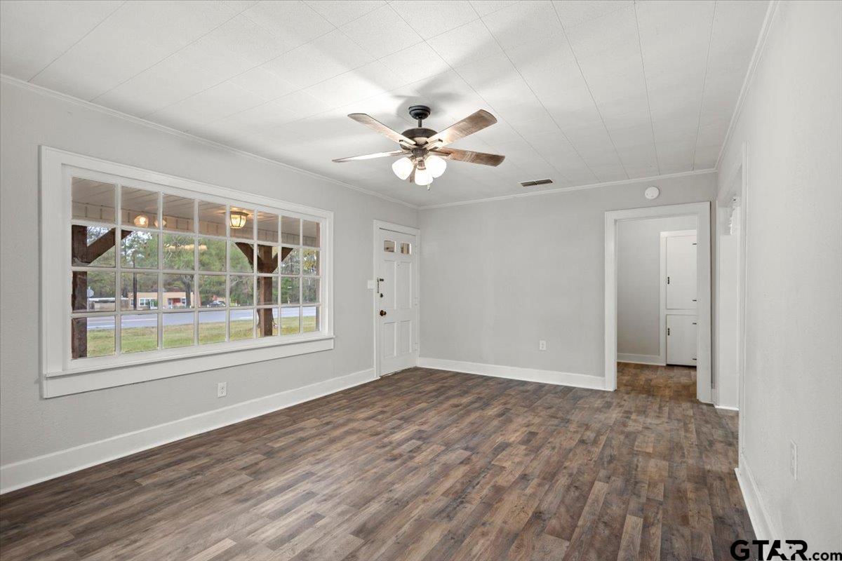 2707 Dudley Road Kilgore, TX 75662 - Photo 6 of 29 a view of an empty room with a window and a ceiling fan