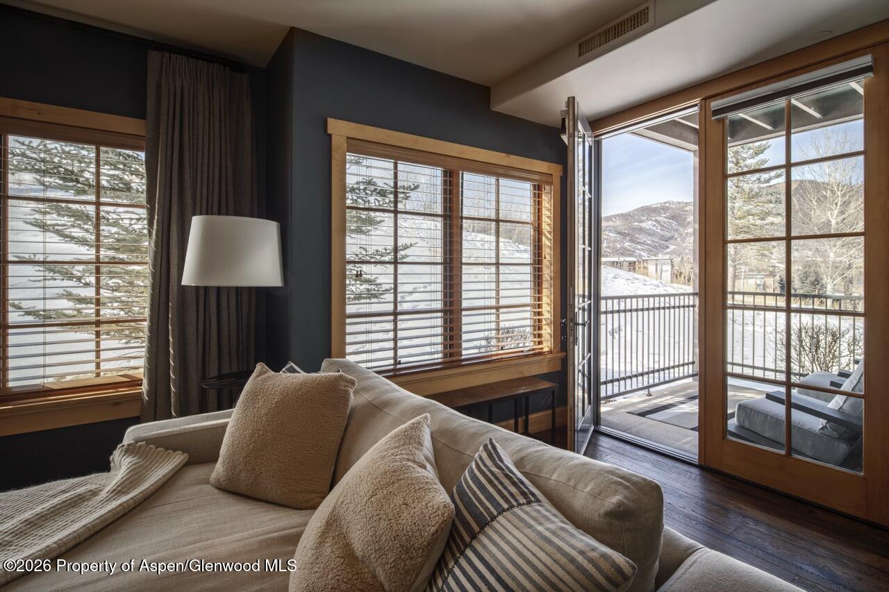 425 Wood Road, Unit 58F Snowmass Village, CO 81615 - Photo 14 of 32 a bedroom with a large bed and a large window