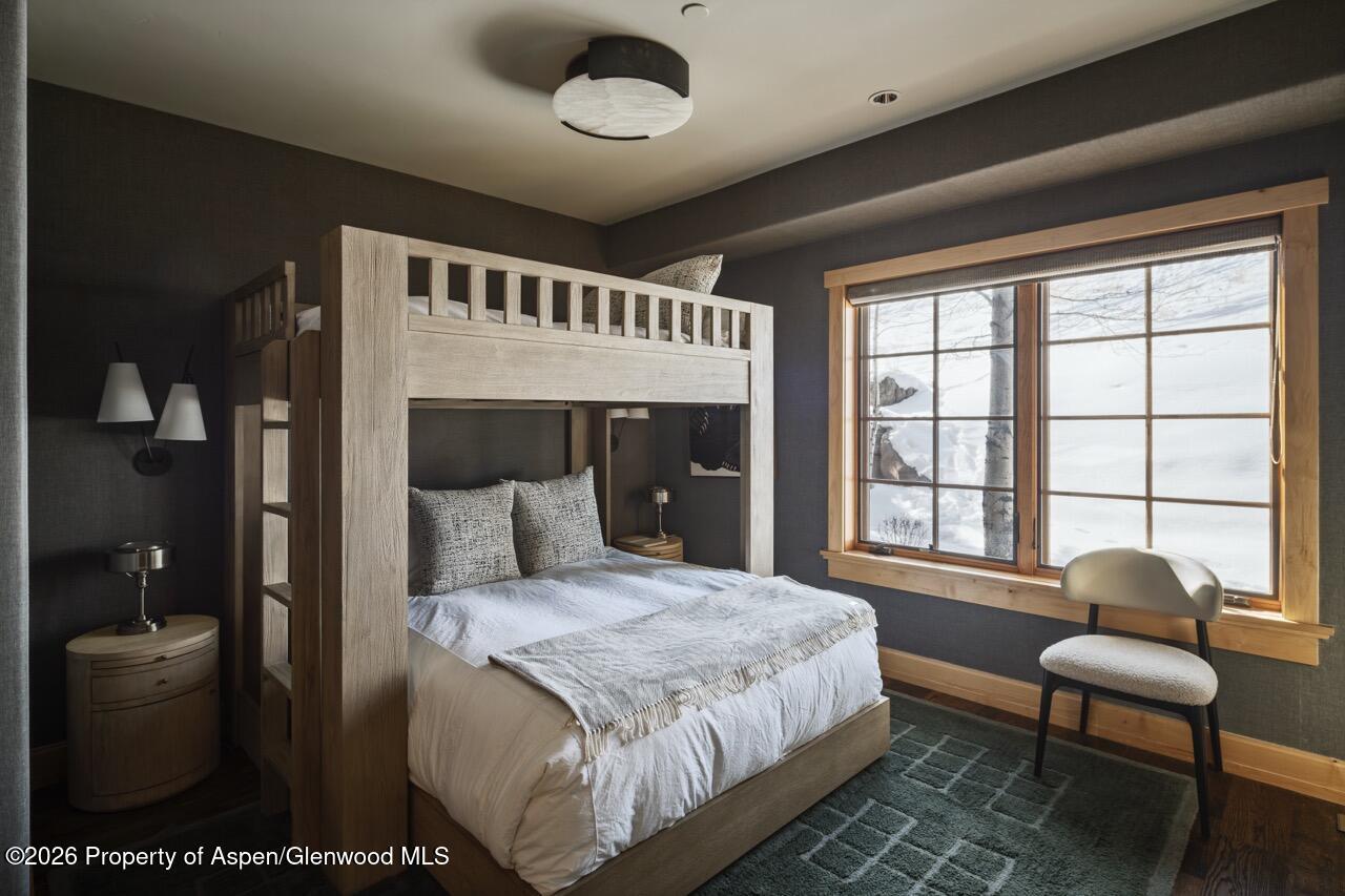 425 Wood Road, Unit 58F Snowmass Village, CO 81615 - Photo 18 of 32 a spacious bedroom with a bed and a large window