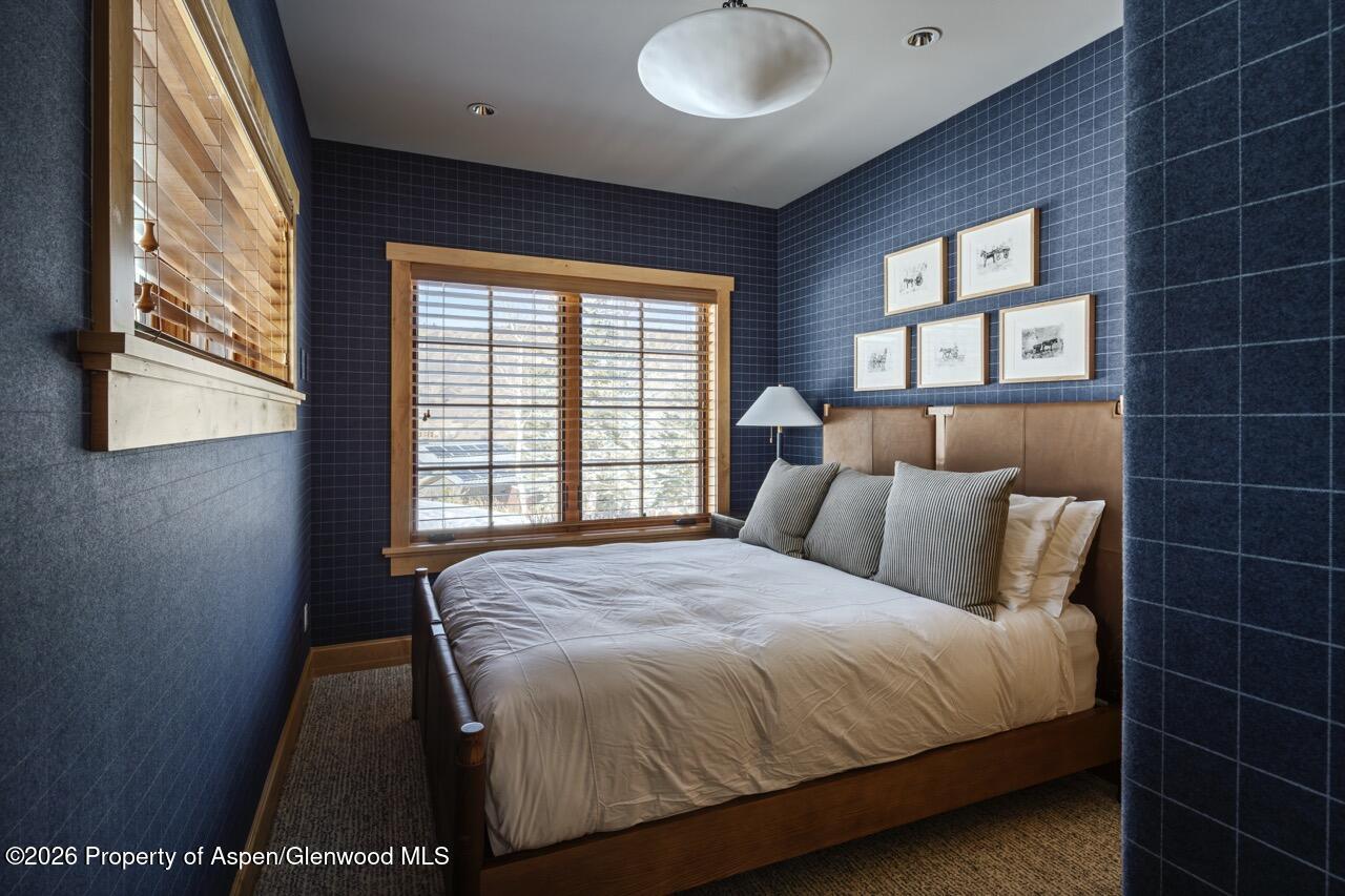 425 Wood Road, Unit 58F Snowmass Village, CO 81615 - Photo 20 of 32 a bedroom with a bed and a window