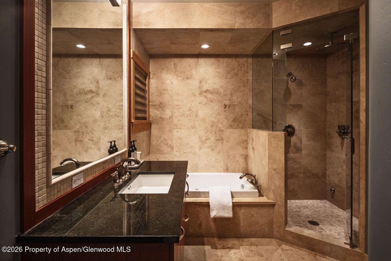 425 Wood Road, Unit 58F Snowmass Village, CO 81615 - Photo 22 of 32 a bathroom with a glass shower door