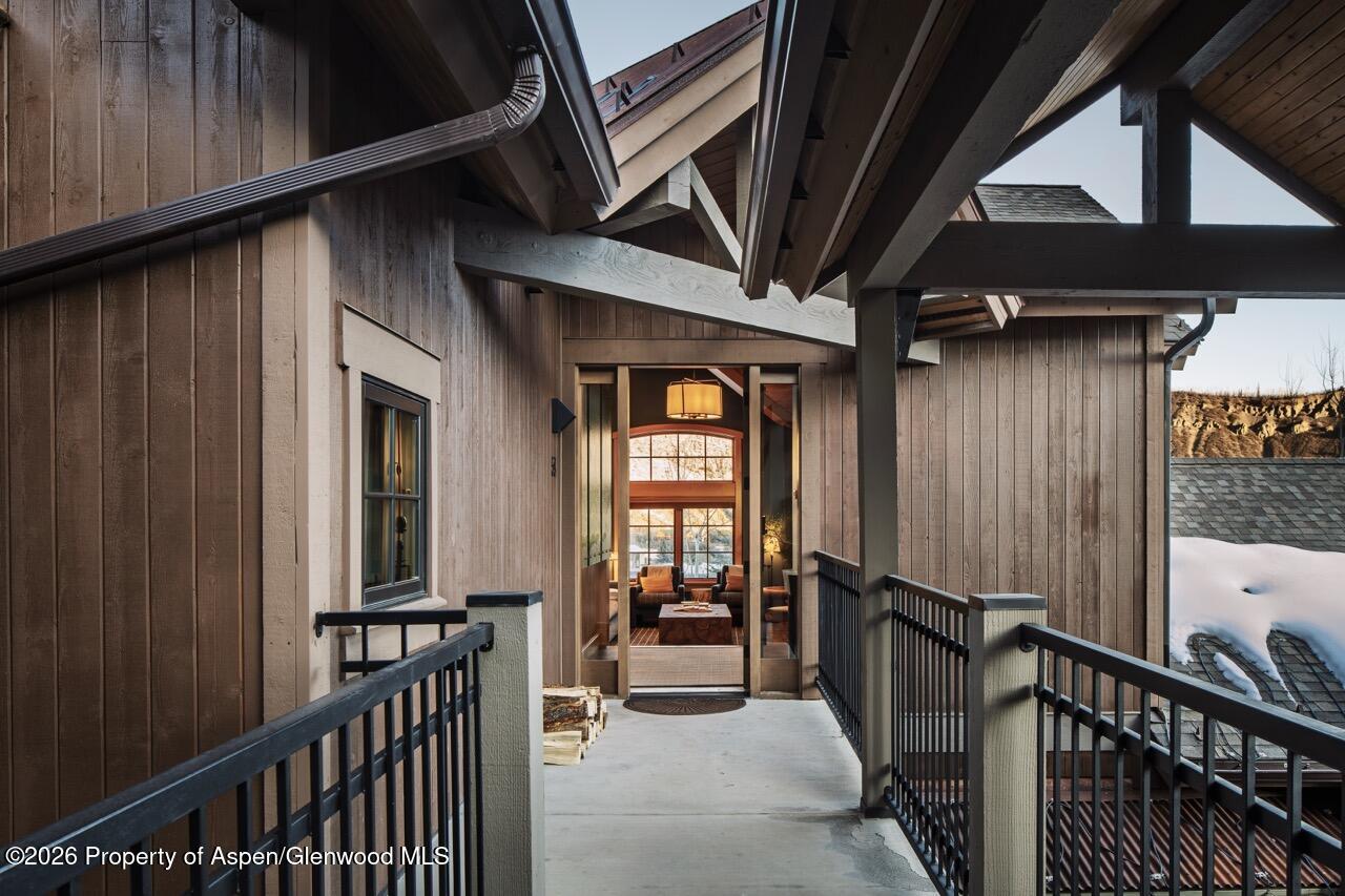 425 Wood Road, Unit 58F Snowmass Village, CO 81615 - Photo 3 of 32 a view of a porch with wooden floor and furniture