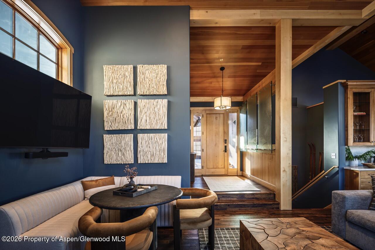 425 Wood Road, Unit 58F Snowmass Village, CO 81615 - Photo 6 of 32 a room with furniture and a flat screen tv