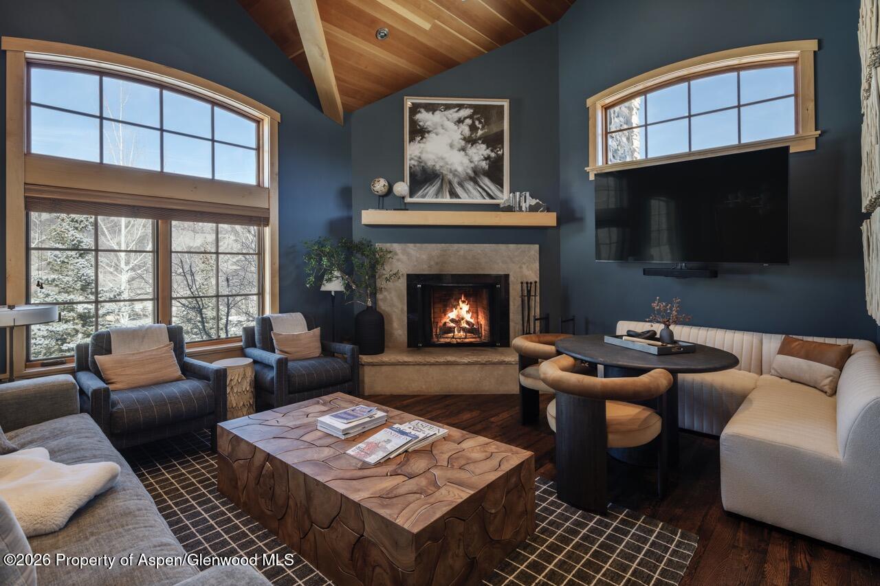 425 Wood Road, Unit 58F Snowmass Village, CO 81615 - Photo 7 of 32 a living room with furniture a flat screen tv and a fireplace