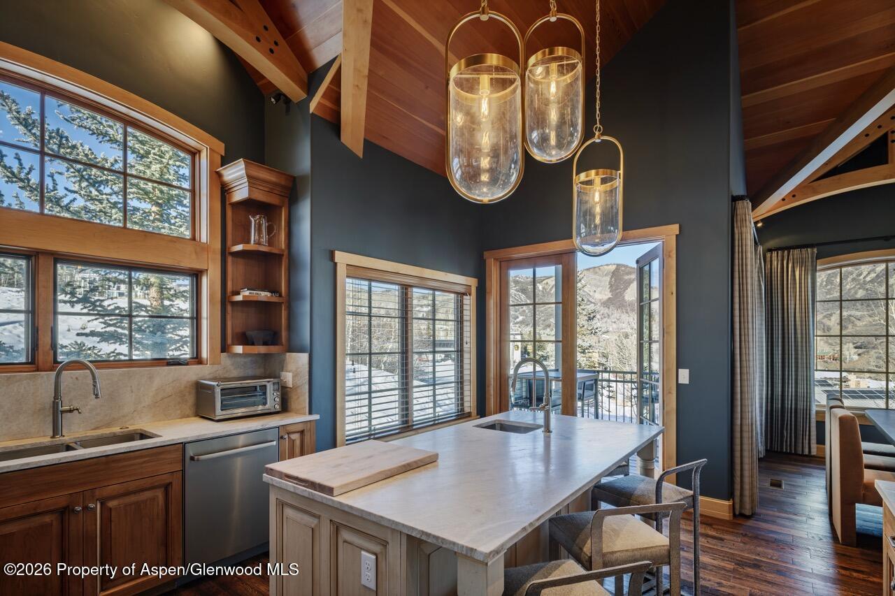 425 Wood Road, Unit 58F Snowmass Village, CO 81615 - Photo 9 of 32 a kitchen with a table and chairs in it