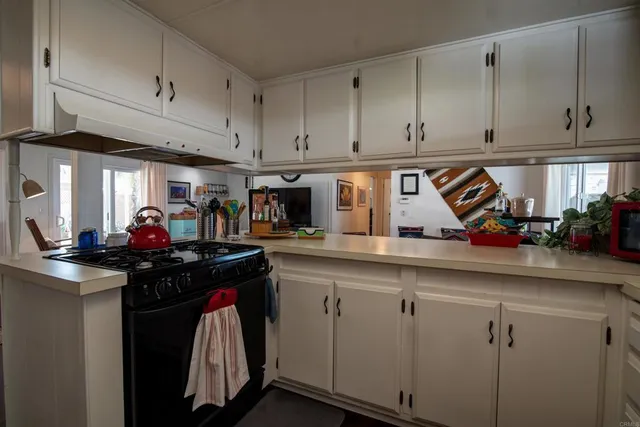 a kitchen with cabinets appliances and a sink