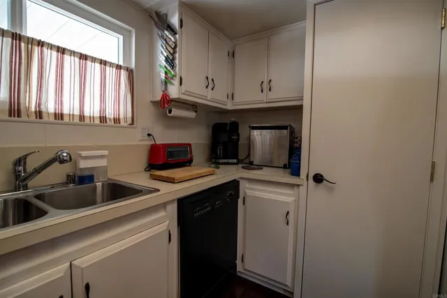 a kitchen with a sink cabinets and a window