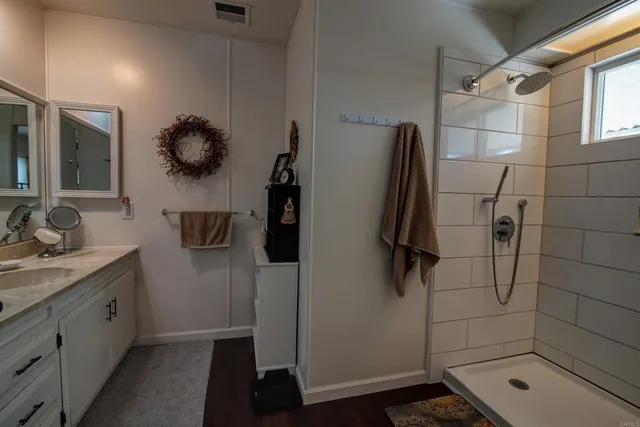 a bathroom with a shower and a sink