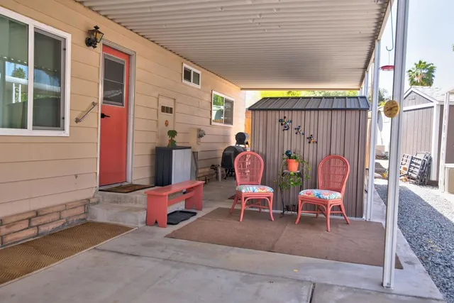a view of a chairs and tables in the back yard of the house
