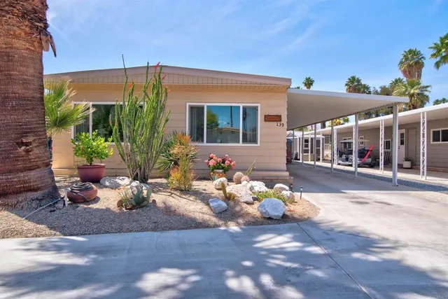 a view of a patio with table and chairs and potted plants