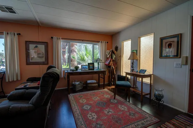 a living room with furniture rug and a window