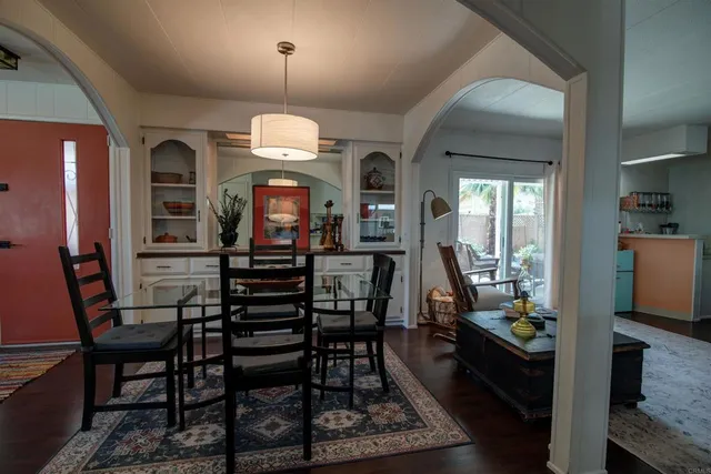 a view of a dining room with furniture and a chandelier