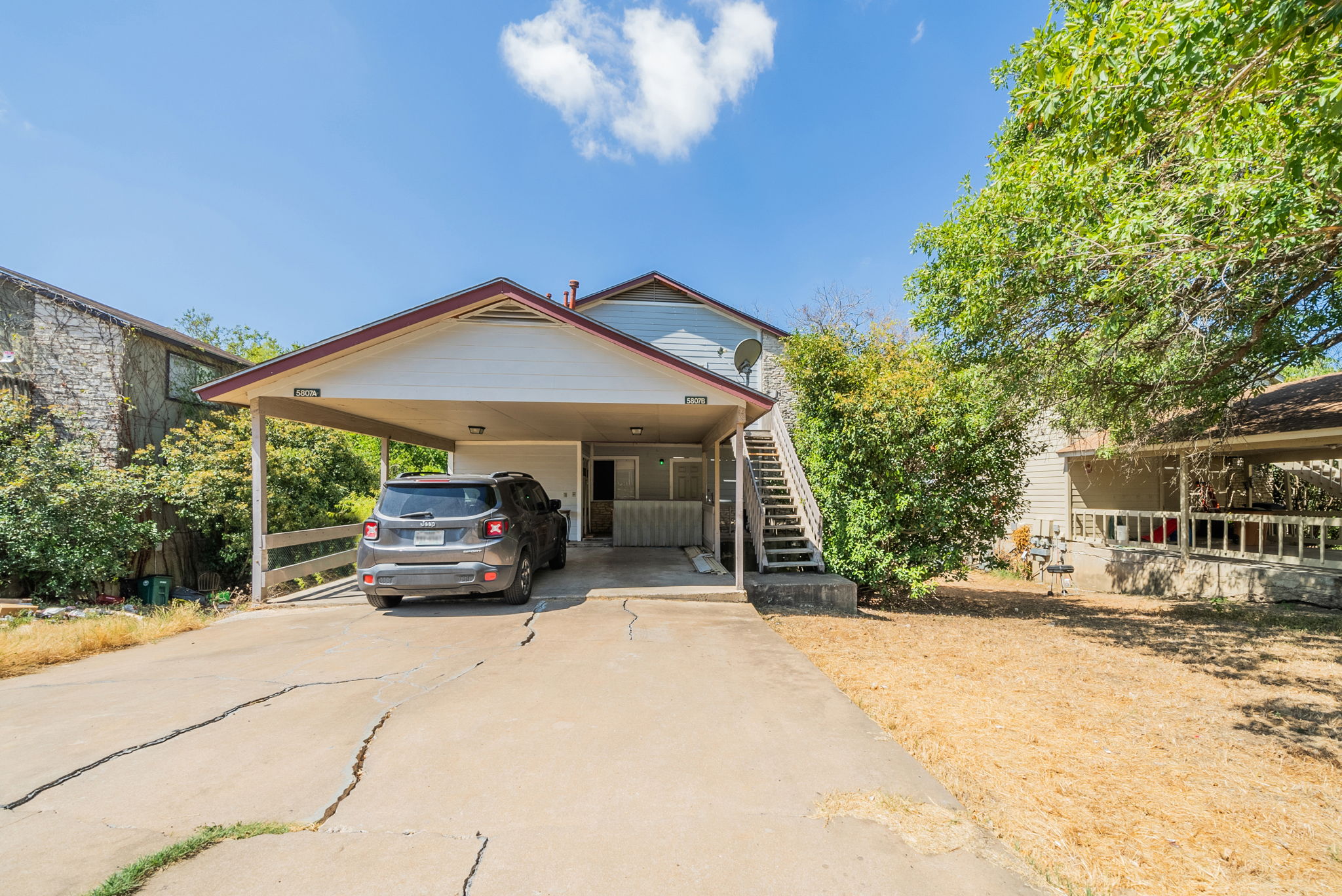 5807 Spring Meadow Road, Unit B Austin, TX 78744 - Photo 30 of 31 A welcoming front exterior offers a convenient carport and accessible outdoor stairs.