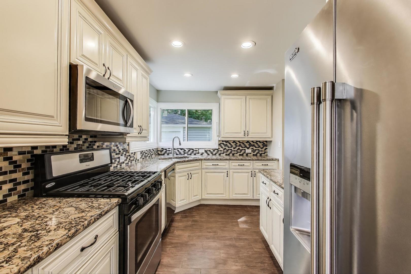 600 Long Road Glenview, IL 60025 - Photo 11 of 33 a kitchen with stainless steel appliances granite countertop a sink stove and refrigerator
