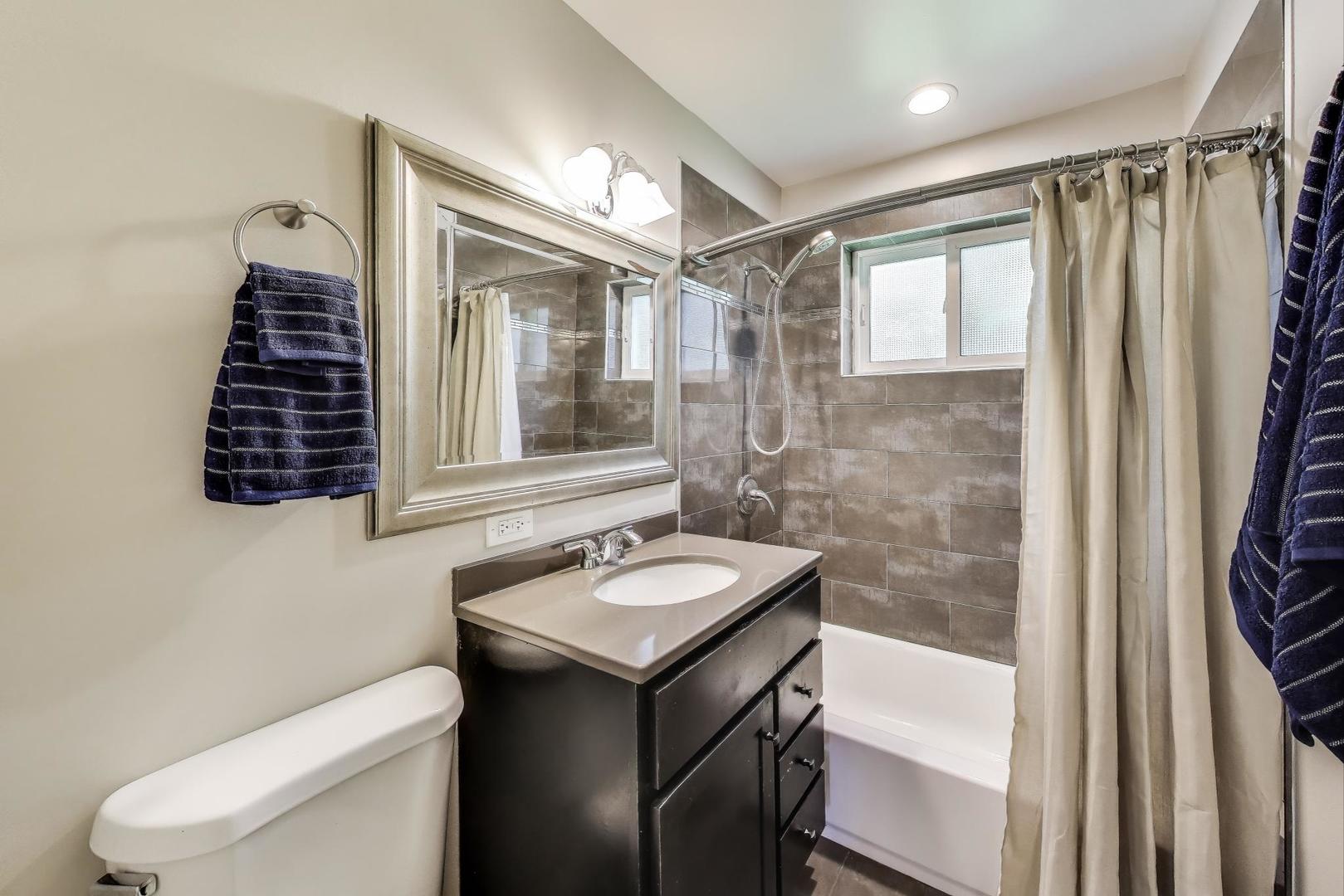 600 Long Road Glenview, IL 60025 - Photo 16 of 33 a bathroom with a sink toilet and shower
