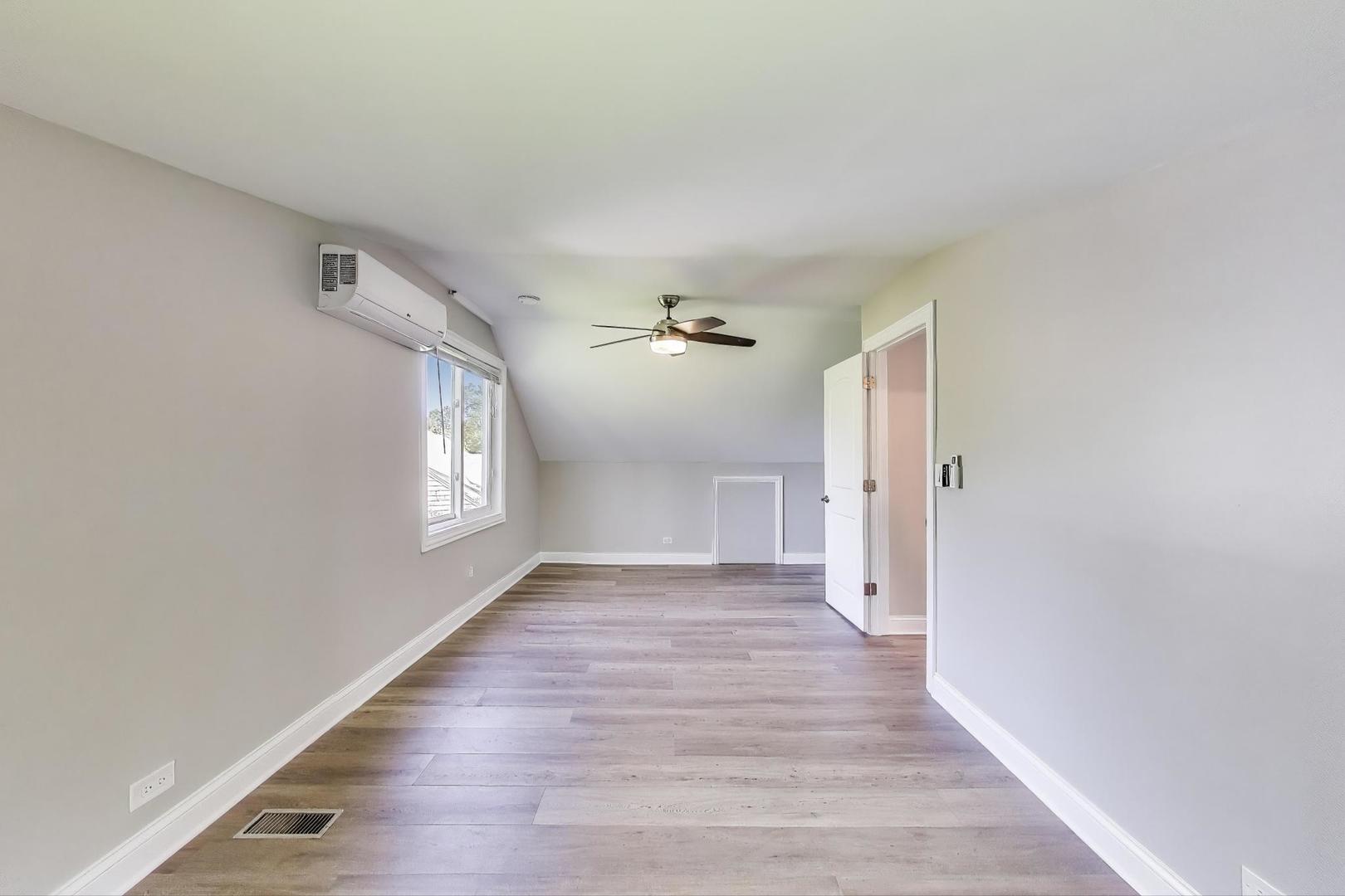 600 Long Road Glenview, IL 60025 - Photo 23 of 33 wooden floor in an empty room with a window