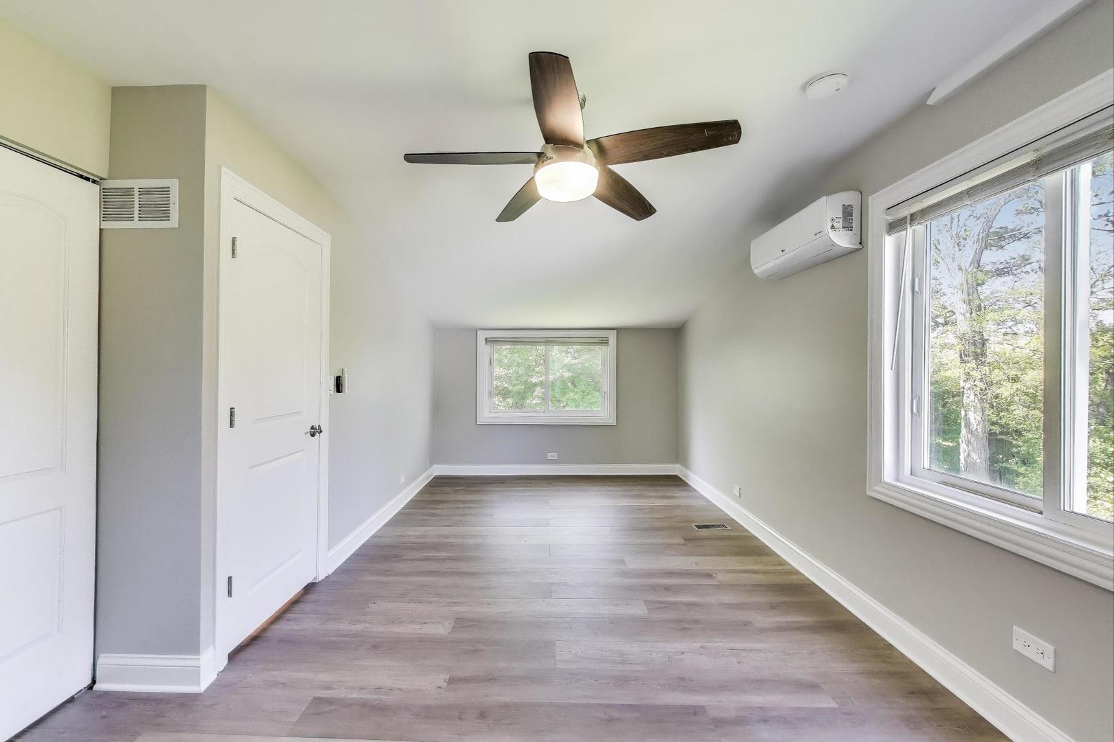 600 Long Road Glenview, IL 60025 - Photo 24 of 33 a view of an empty room with a window and wooden floor