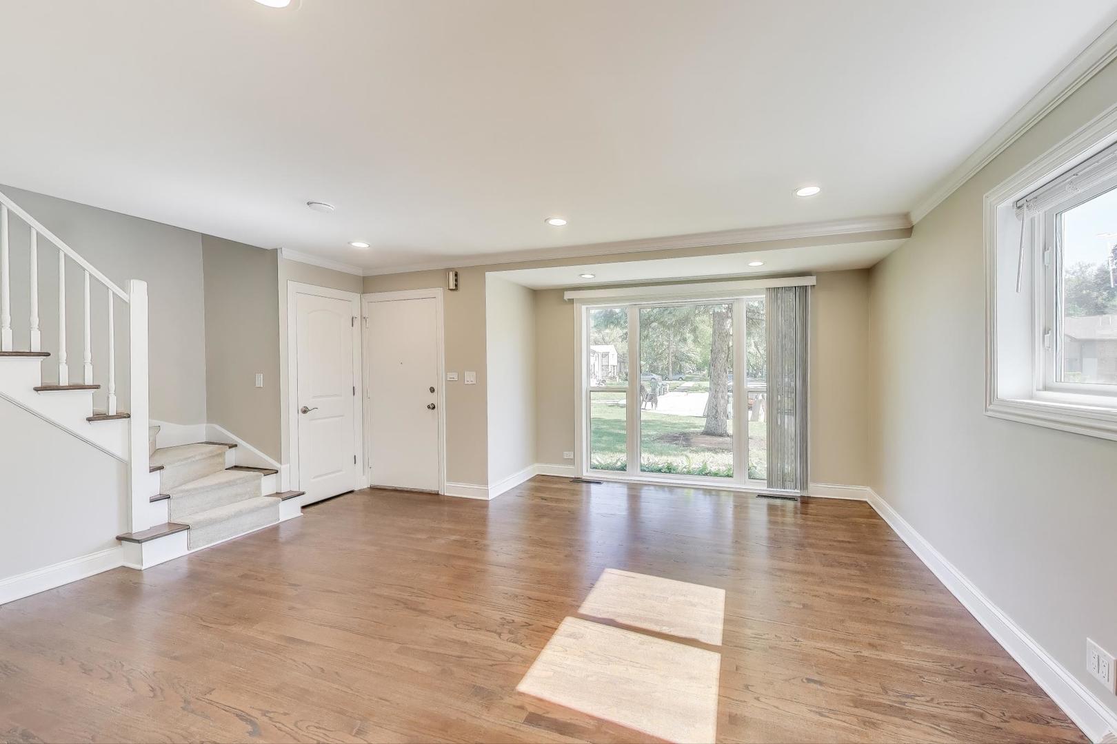 600 Long Road Glenview, IL 60025 - Photo 3 of 33 a view of an empty room with wooden floor and a window