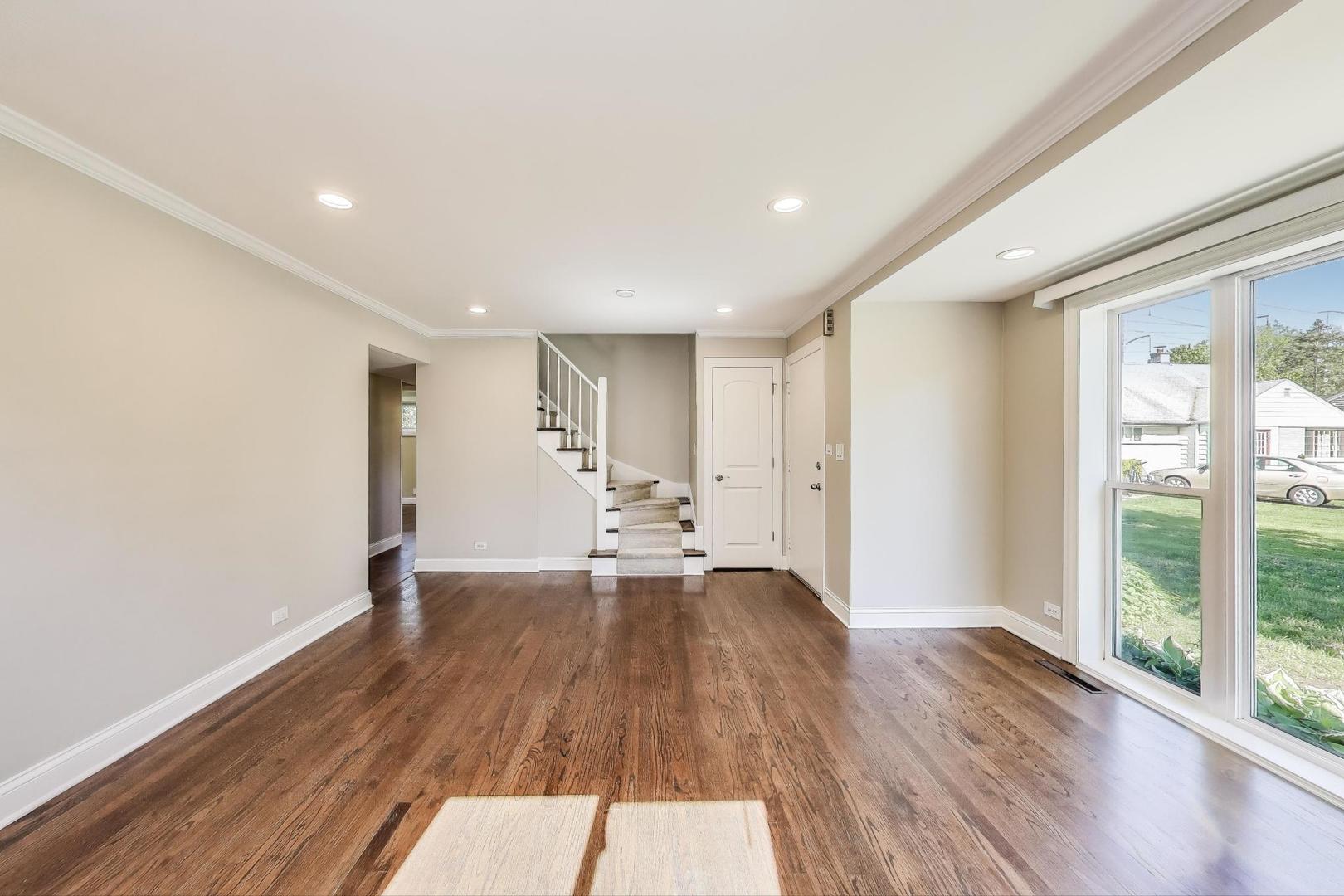600 Long Road Glenview, IL 60025 - Photo 4 of 33 a view of an empty room with wooden floor and a window