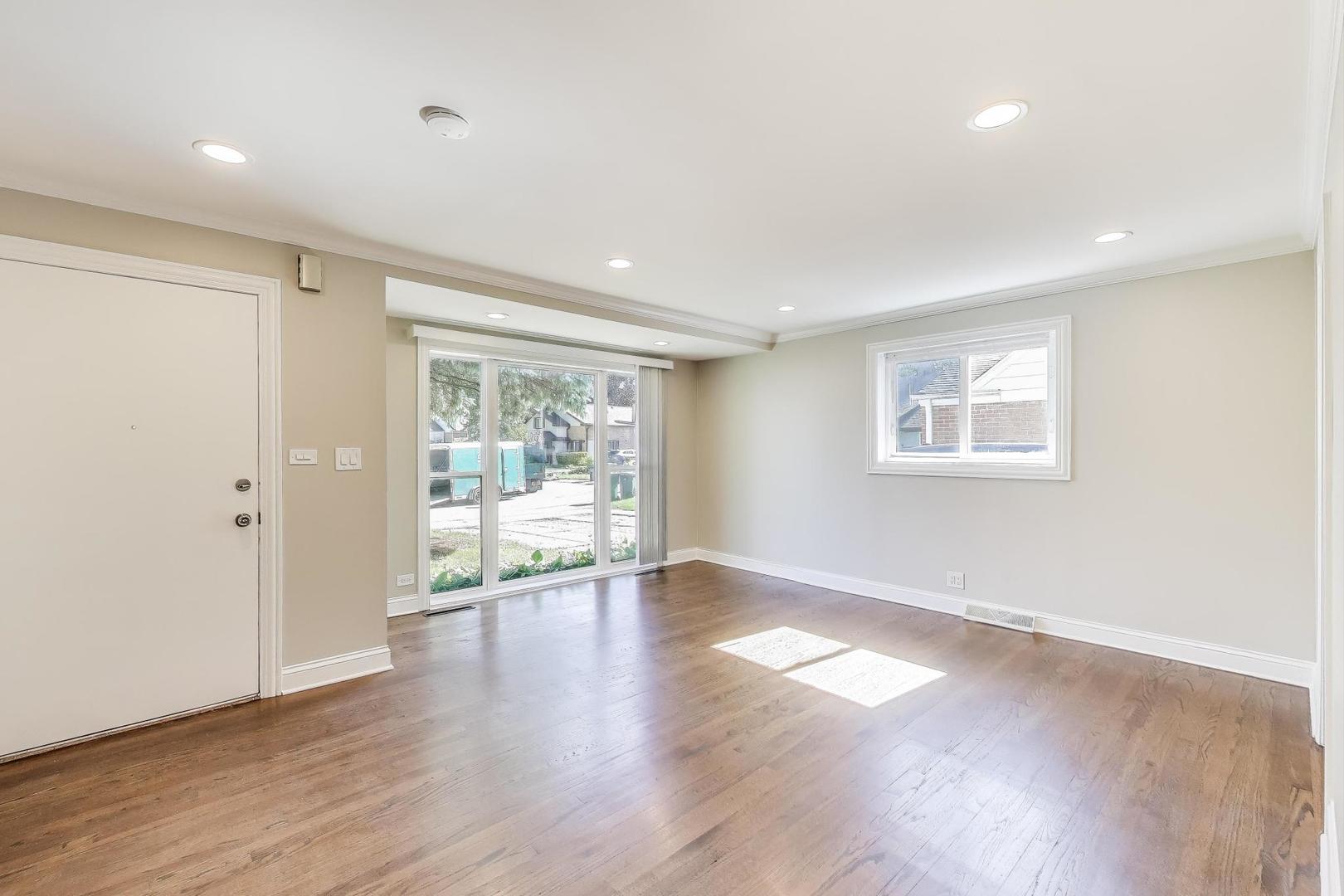 600 Long Road Glenview, IL 60025 - Photo 5 of 33 a view of an empty room with wooden floor and a window
