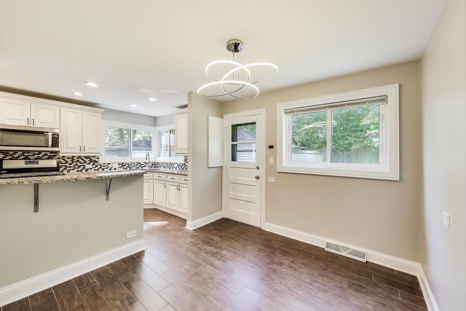 600 Long Road Glenview, IL 60025 - Photo 6 of 33 a kitchen with stainless steel appliances granite countertop a stove and a refrigerator