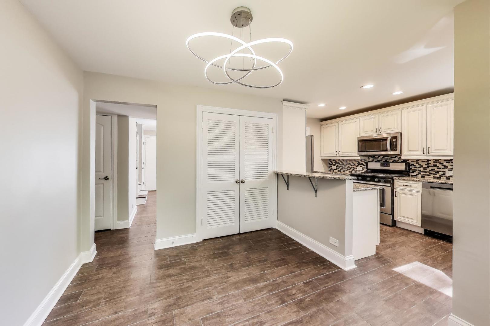 600 Long Road Glenview, IL 60025 - Photo 7 of 33 a kitchen with a refrigerator and white cabinets
