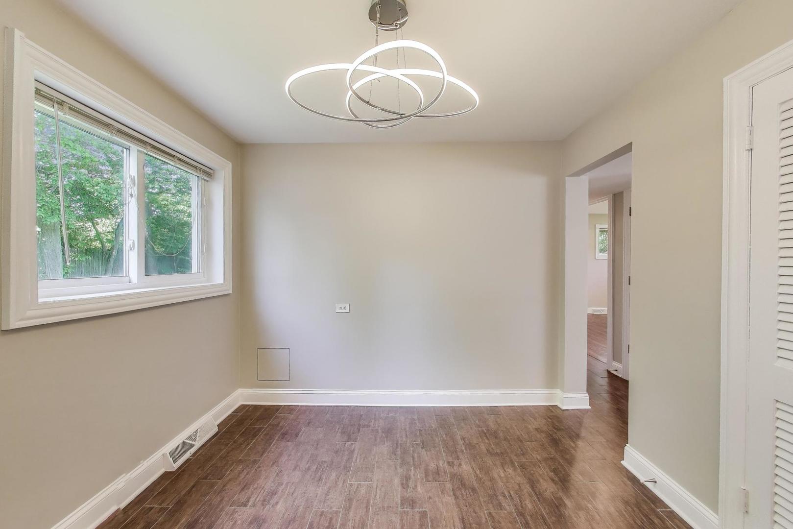600 Long Road Glenview, IL 60025 - Photo 8 of 33 a view of an empty room with wooden floor and a window