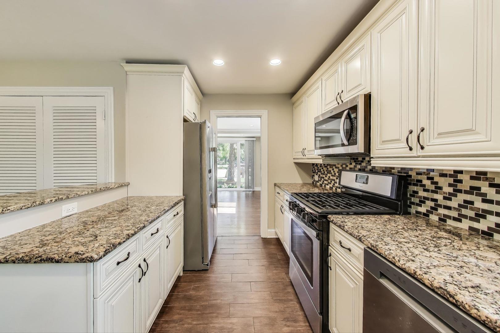 600 Long Road Glenview, IL 60025 - Photo 10 of 33 a kitchen with stainless steel appliances granite countertop a stove and a sink