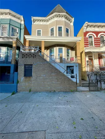 a front view of a residential apartment building with a yard