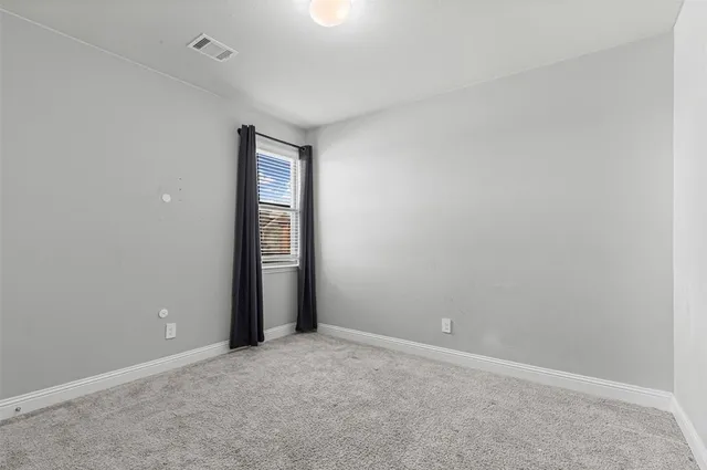 an empty room with closet and mirror