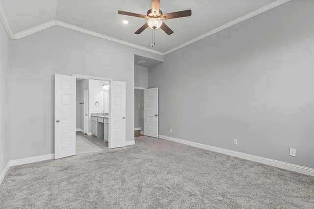 an empty room with closet and a ceiling fan