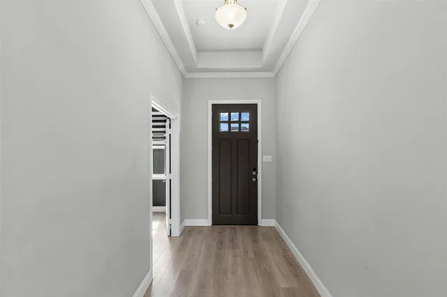 a view of a hallway with wooden floor