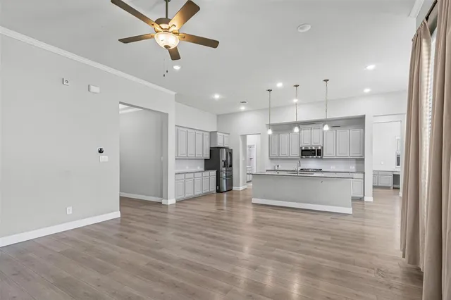 a view of kitchen with stainless steel appliances refrigerator oven and cabinets