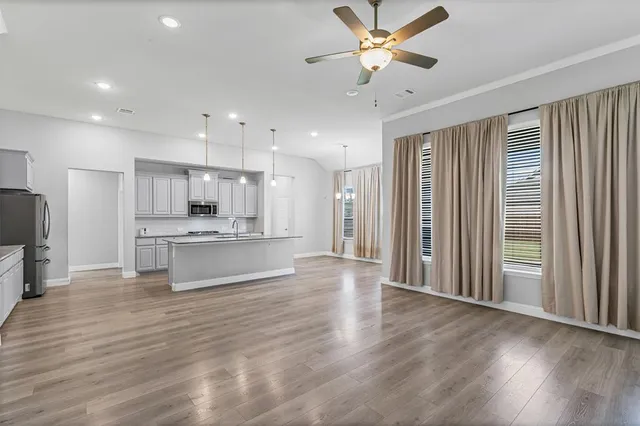 a large kitchen with kitchen island a sink stainless steel appliances and cabinets