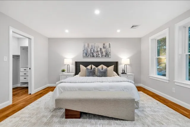 a spacious bedroom with a bed and a window