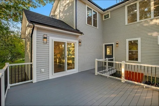 a view of a house with wooden deck