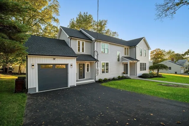 a front view of a house with a yard and garage