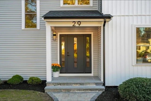 a front view of a house with potted plants