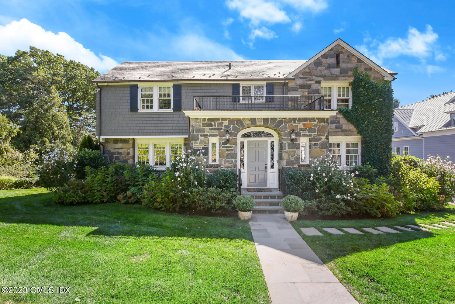 a front view of a house with garden