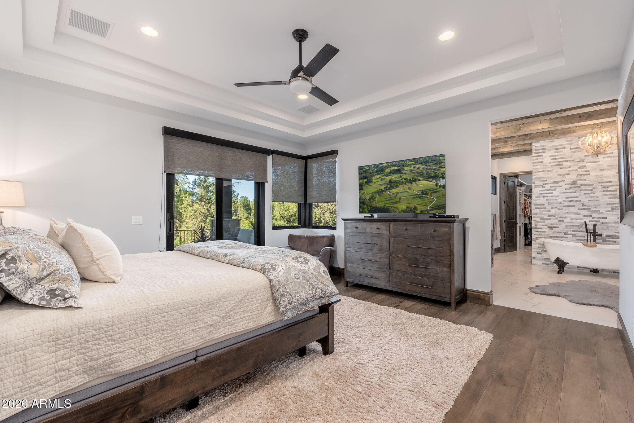 602 North Redbud Circle Payson, AZ 85541 - Photo 24 of 83 a bedroom with a large bed and wooden floor