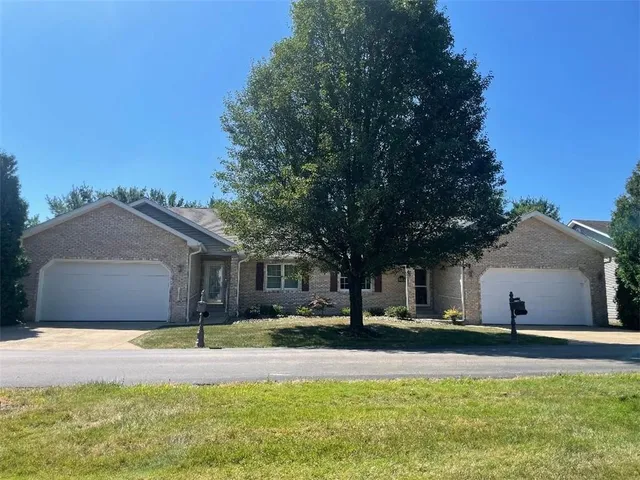 a front view of house with yard and trees