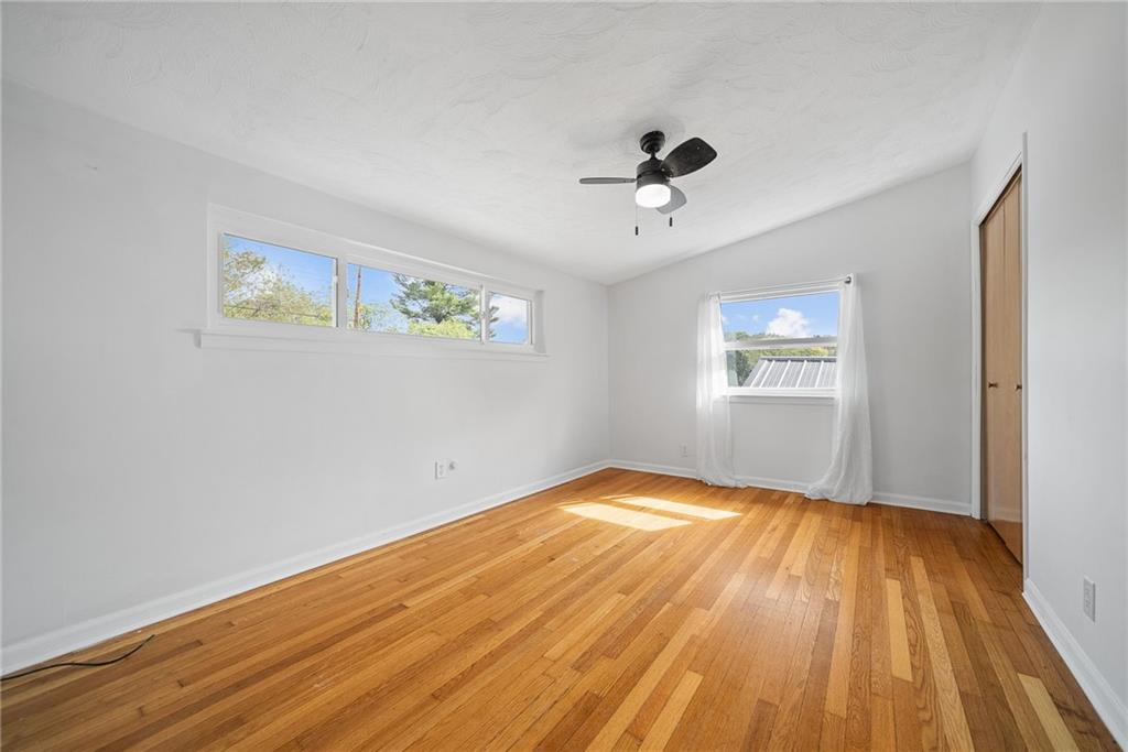211 Stuber Road New Brighton, PA 15066 - Photo 23 of 33 a view of empty room with wooden floor and fan