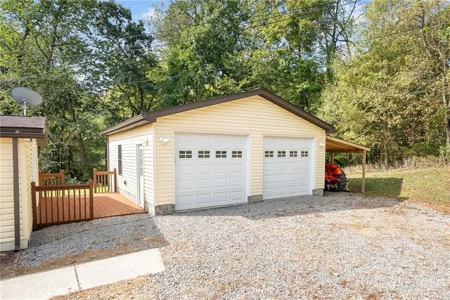 a view of a house with a yard and wooden fence